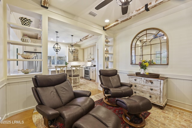 625 Spanish Wells Rd Unit 12, Hilton Head Island, SC 29926 - sitting room featuring visible vents, a decorative wall, ceiling fan, recessed lighting, and a wainscoted wall