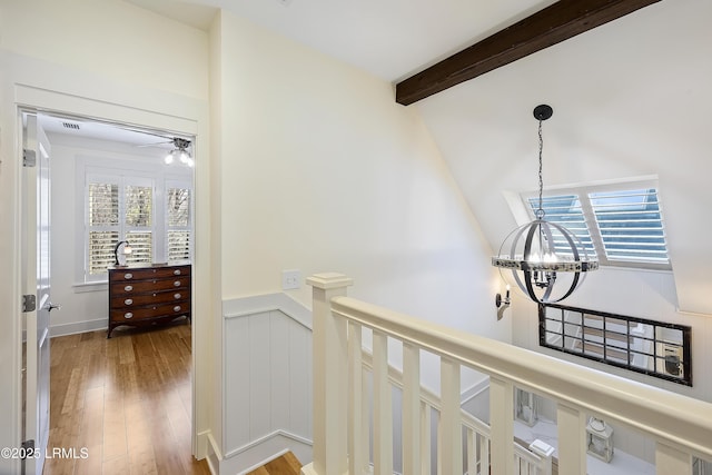 625 Spanish Wells Rd Unit 12, Hilton Head Island, SC 29926 - hallway with an inviting chandelier, wood finished floors, a healthy amount of sunlight, and an upstairs landing