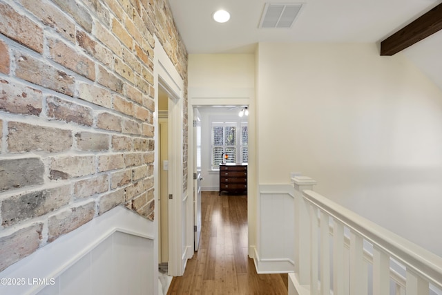 625 Spanish Wells Rd Unit 12, Hilton Head Island, SC 29926 - corridor with light wood-style flooring, an upstairs landing, brick wall, and visible vents