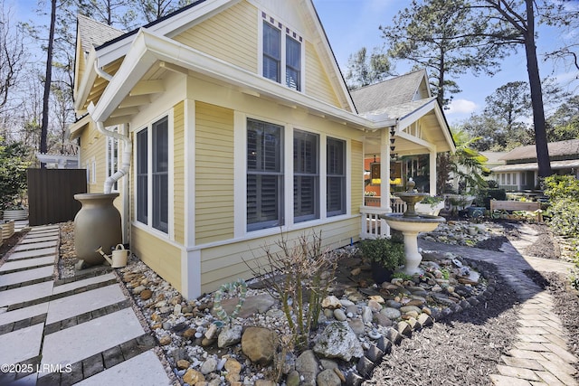 625 Spanish Wells Rd Unit 12, Hilton Head Island, SC 29926 - view of property exterior with fence and roof with shingles
