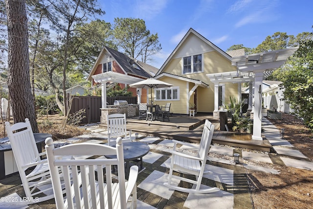 625 Spanish Wells Rd Unit 12, Hilton Head Island, SC 29926 - back of property featuring fence, a pergola, a deck, a patio area, and outdoor dining space