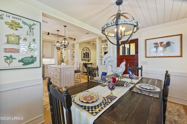 625 Spanish Wells Rd Unit 12, Hilton Head Island, SC 29926 - dining area featuring an inviting chandelier and wainscoting