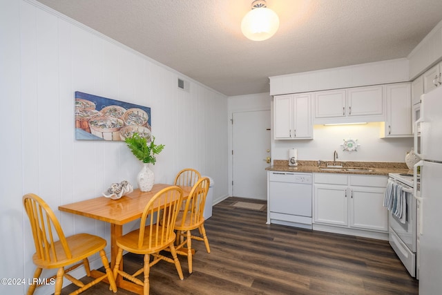 kitchen with white appliances, sink, a textured ceiling, and white cabinets