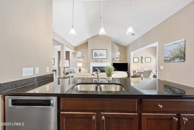 kitchen with dishwasher, dark stone countertops, sink, and pendant lighting