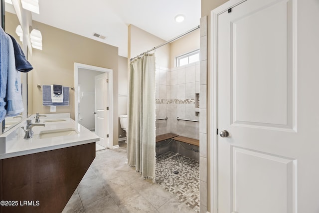 bathroom with a shower with curtain, tile patterned floors, toilet, and vanity