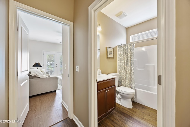 full bathroom with vanity, wood-type flooring, toilet, and shower / bath combo