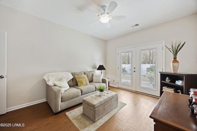 living room featuring hardwood / wood-style flooring, french doors, and ceiling fan