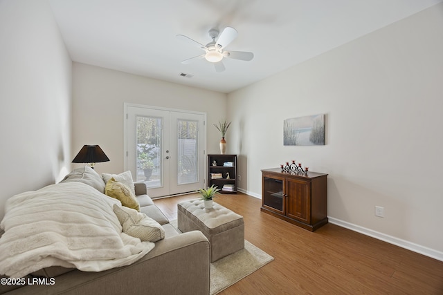 living room featuring hardwood / wood-style flooring, ceiling fan, and french doors