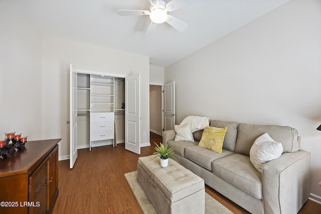 living room featuring wood-type flooring and ceiling fan