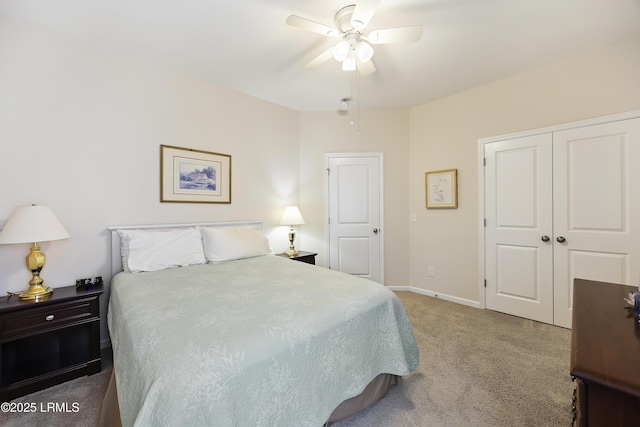 carpeted bedroom featuring ceiling fan and a closet