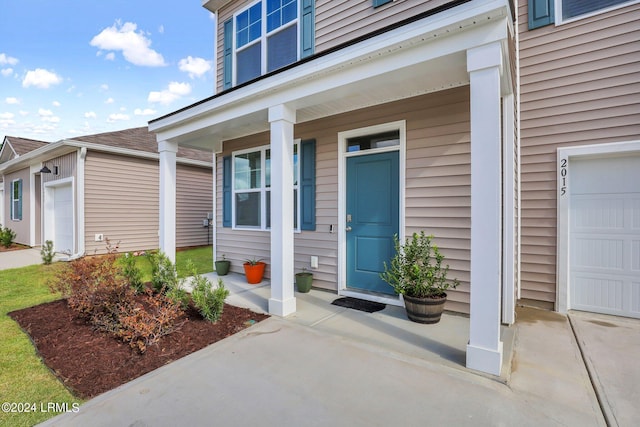 view of exterior entry with covered porch