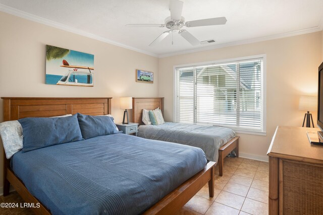 tiled bedroom with ornamental molding and ceiling fan