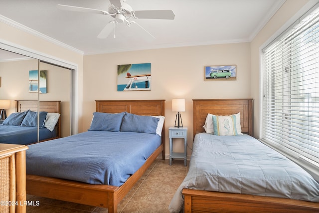 tiled bedroom with ornamental molding, ceiling fan, and a closet