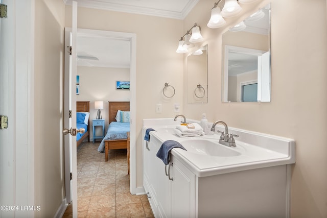 bathroom with crown molding, tile patterned floors, and vanity