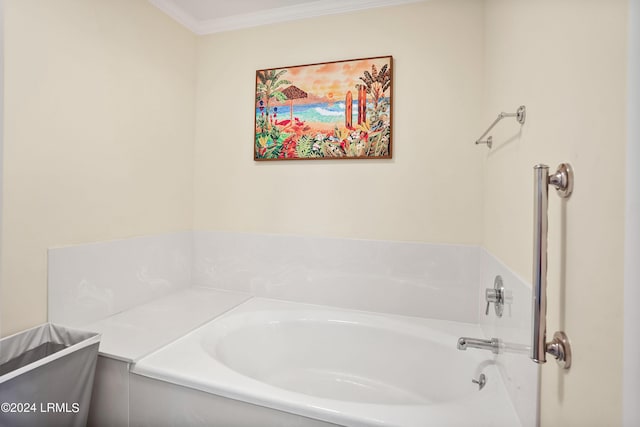 bathroom featuring ornamental molding and a tub to relax in