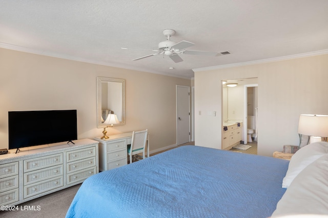 carpeted bedroom featuring ornamental molding, ceiling fan, and ensuite bathroom