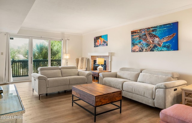 living room with hardwood / wood-style flooring and ornamental molding