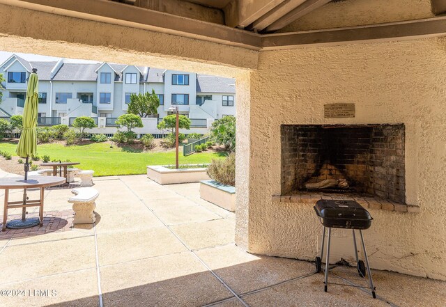 view of patio with an outdoor fireplace