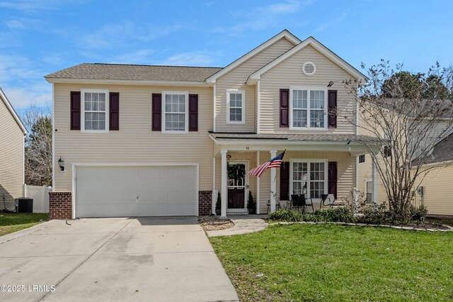 76 Shadow Moss Dr, Beaufort, SC 29906 - traditional-style house featuring covered porch, central AC, concrete driveway, a garage, and a front lawn