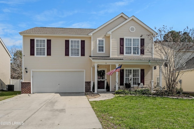 traditional-style house with an attached garage, a front lawn, concrete driveway, and brick siding