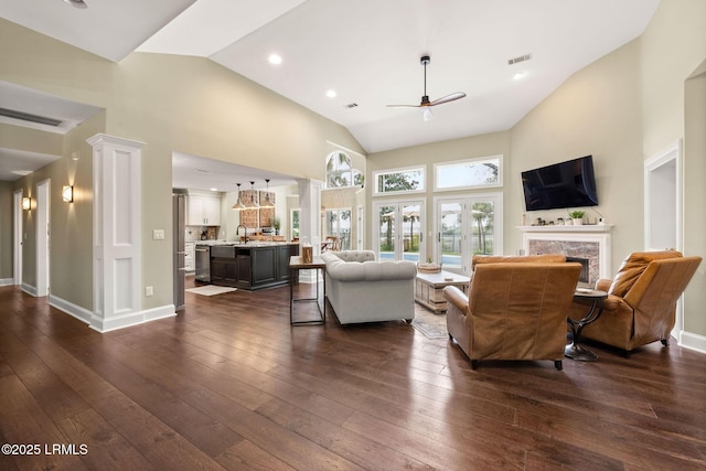 8 Wild Magnolia Ln, Okatie, SC 29909 - living room featuring baseboards, a ceiling fan, dark wood finished floors, high vaulted ceiling, and a high end fireplace