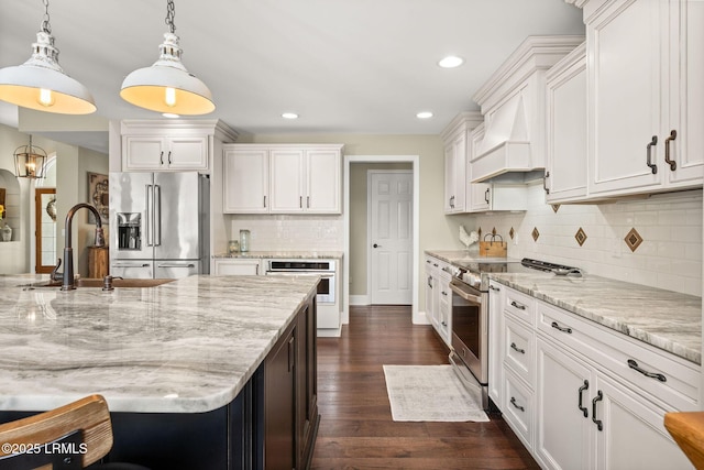 8 Wild Magnolia Ln, Okatie, SC 29909 - kitchen featuring custom range hood, dark wood-style flooring, white cabinets, stainless steel appliances, and a sink