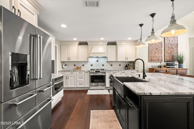 8 Wild Magnolia Ln, Okatie, SC 29909 - kitchen featuring custom exhaust hood, tasteful backsplash, dark wood-type flooring, visible vents, and appliances with stainless steel finishes