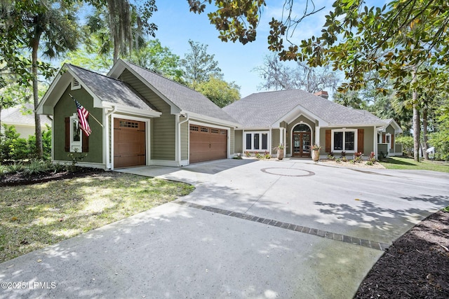 8 Wild Magnolia Ln, Okatie, SC 29909 - view of front of house with a shingled roof, a garage, a chimney, french doors, and driveway