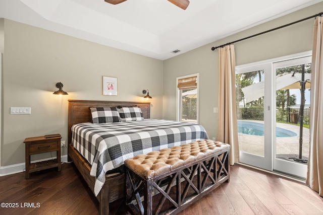 8 Wild Magnolia Ln, Okatie, SC 29909 - bedroom with access to outside, baseboards, visible vents, a tray ceiling, and hardwood / wood-style flooring