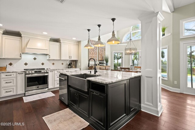 8 Wild Magnolia Ln, Okatie, SC 29909 - kitchen with tasteful backsplash, premium range hood, white cabinets, stainless steel range, and a sink