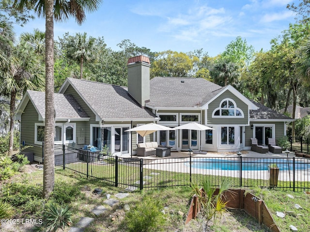 8 Wild Magnolia Ln, Okatie, SC 29909 - rear view of property featuring a patio, an outdoor hangout area, a fenced in pool, and fence