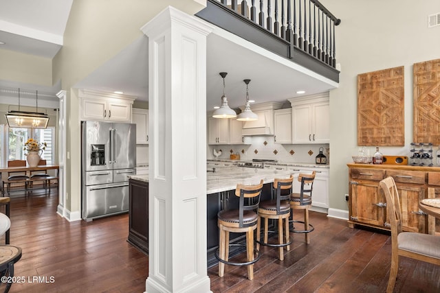 8 Wild Magnolia Ln, Okatie, SC 29909 - kitchen featuring stainless steel fridge with ice dispenser, dark wood-style floors, light stone countertops, visible vents, and stove