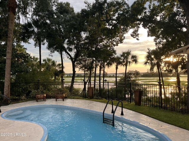 8 Wild Magnolia Ln, Okatie, SC 29909 - pool at dusk featuring a patio area, a fenced in pool, and fence