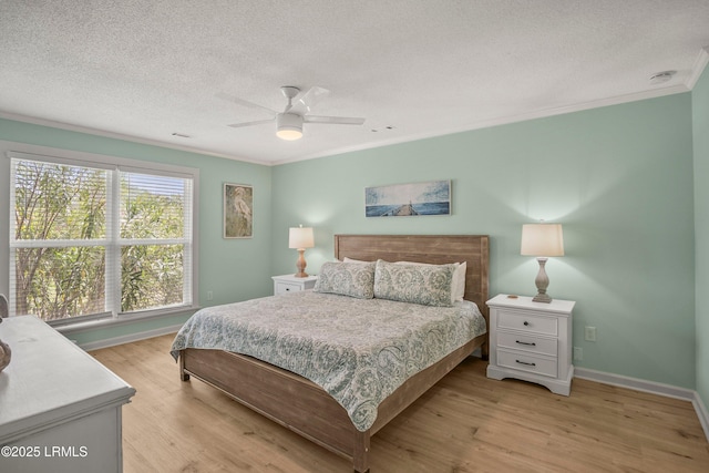 26 Fairway Club Dr, Fripp Island, SC 29920 - bedroom with crown molding, a textured ceiling, baseboards, and light wood-style flooring