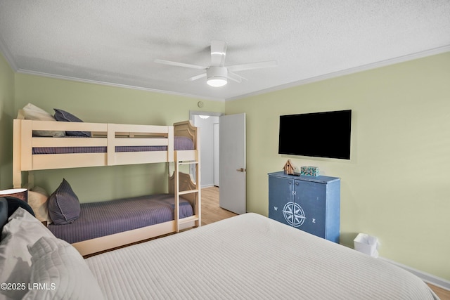 26 Fairway Club Dr, Fripp Island, SC 29920 - bedroom with ceiling fan, a textured ceiling, wood finished floors, baseboards, and ornamental molding