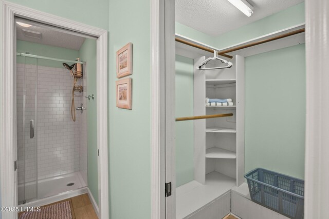 26 Fairway Club Dr, Fripp Island, SC 29920 - full bathroom with a shower stall and a textured ceiling