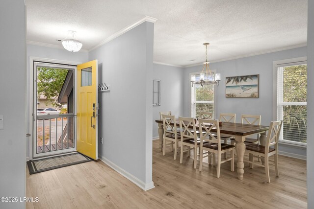 26 Fairway Club Dr, Fripp Island, SC 29920 - dining area with an inviting chandelier, baseboards, light wood-type flooring, and a textured ceiling