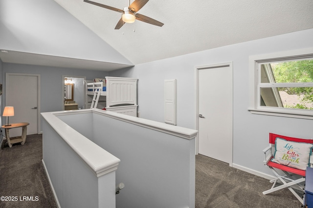 26 Fairway Club Dr, Fripp Island, SC 29920 - hallway featuring dark colored carpet, baseboards, lofted ceiling, and an upstairs landing