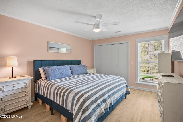 26 Fairway Club Dr, Fripp Island, SC 29920 - bedroom with light wood-type flooring, a textured ceiling, crown molding, and a closet