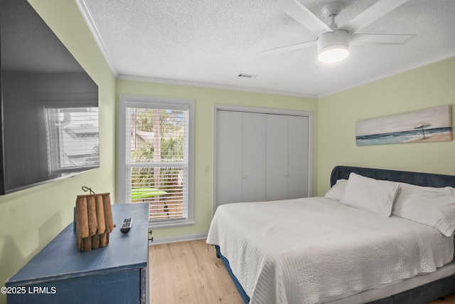 26 Fairway Club Dr, Fripp Island, SC 29920 - bedroom featuring a textured ceiling, visible vents, ornamental molding, and wood finished floors
