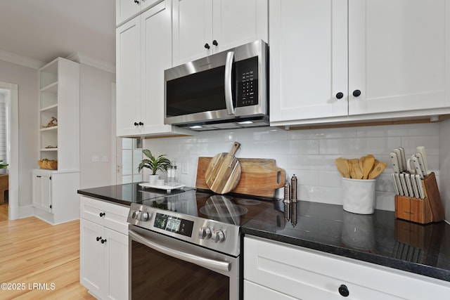 12 Sheffield Ct, Beaufort, SC 29907 - kitchen featuring appliances with stainless steel finishes, white cabinetry, light wood-type flooring, dark stone countertops, and tasteful backsplash