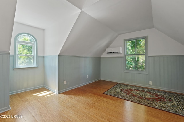 12 Sheffield Ct, Beaufort, SC 29907 - additional living space with an AC wall unit, wood finished floors, a wainscoted wall, and lofted ceiling