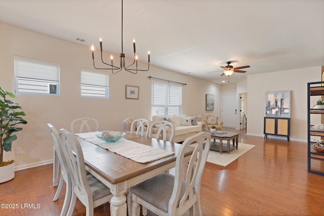 95 Sunrise Point Dr, Okatie, SC 29909 - dining area featuring wood finished floors, a chandelier, ceiling fan, and baseboards