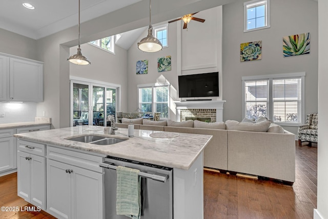 39 Sweet Marsh Ct, Bluffton, SC 29910 - kitchen featuring stainless steel dishwasher, a high ceiling, dark wood-style floors, decorative light fixtures, and white cabinetry