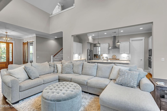 39 Sweet Marsh Ct, Bluffton, SC 29910 - living room featuring crown molding, light wood-style floors, a barn door, recessed lighting, and stairs