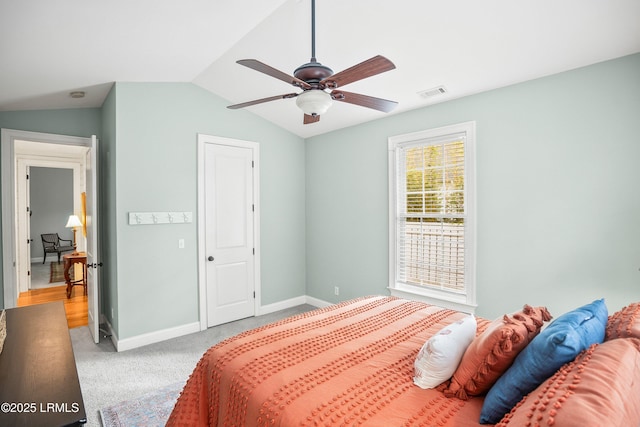 bedroom with light carpet, baseboards, visible vents, a ceiling fan, and vaulted ceiling