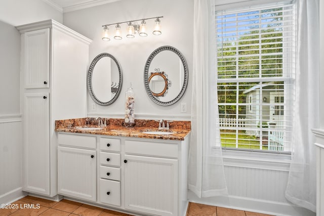 full bath with double vanity, plenty of natural light, and a sink