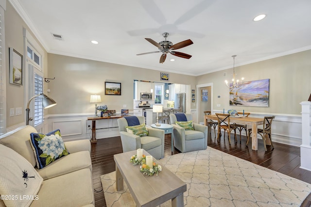 living room with ornamental molding, ceiling fan with notable chandelier, and light hardwood / wood-style flooring