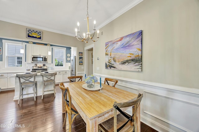 dining room with crown molding, an inviting chandelier, and dark wood-type flooring