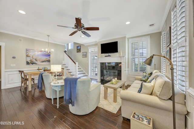 living room with dark hardwood / wood-style flooring, crown molding, and a fireplace